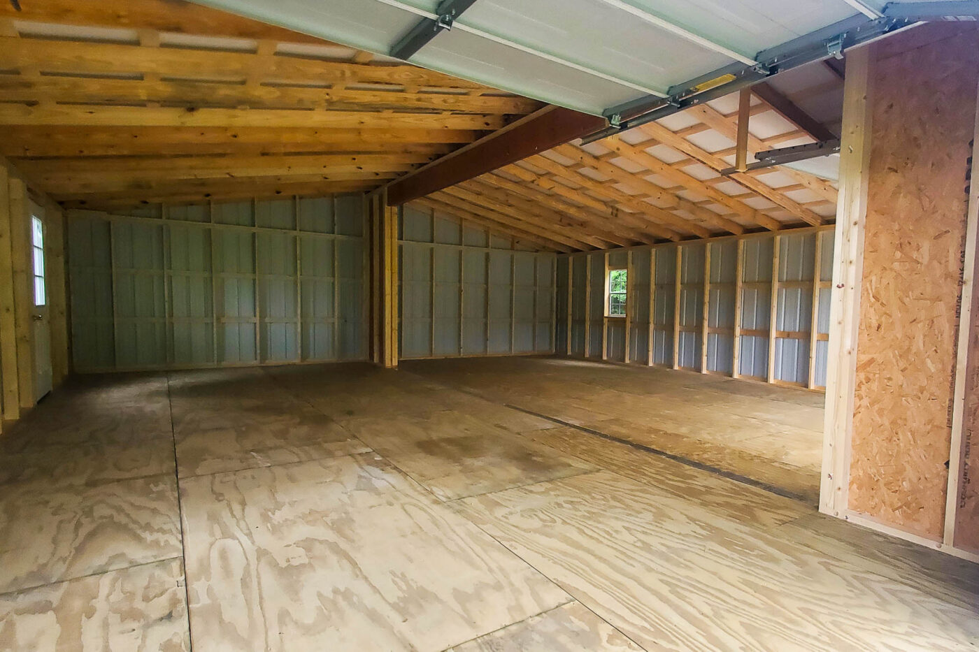 Spacious Interior of 28x32 Shed with Wooden Floor and Metal Walls