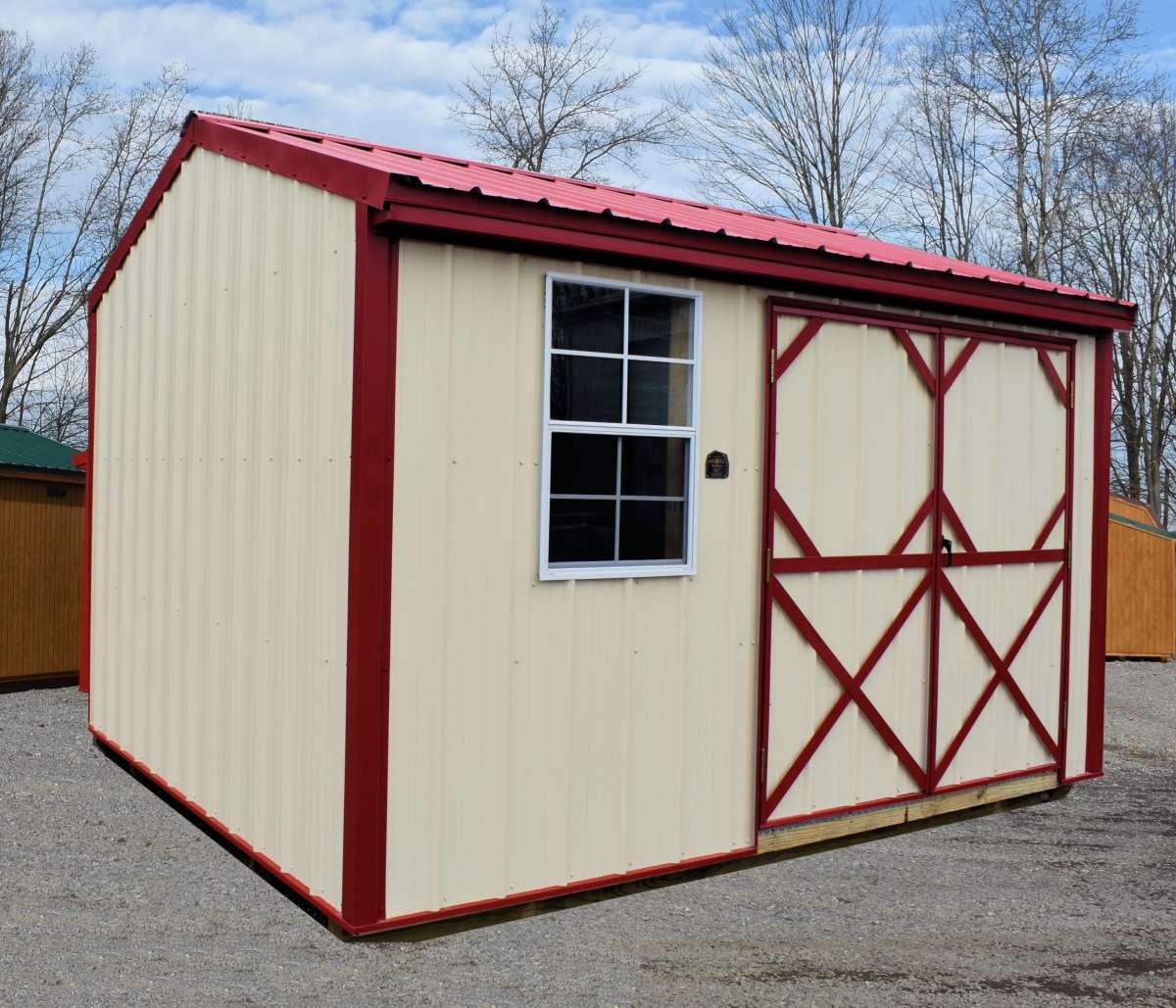 metal storage shed with dark red trim