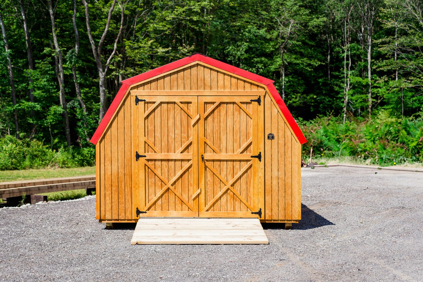 Barn shed with wood siding and a red metal roof used for storage